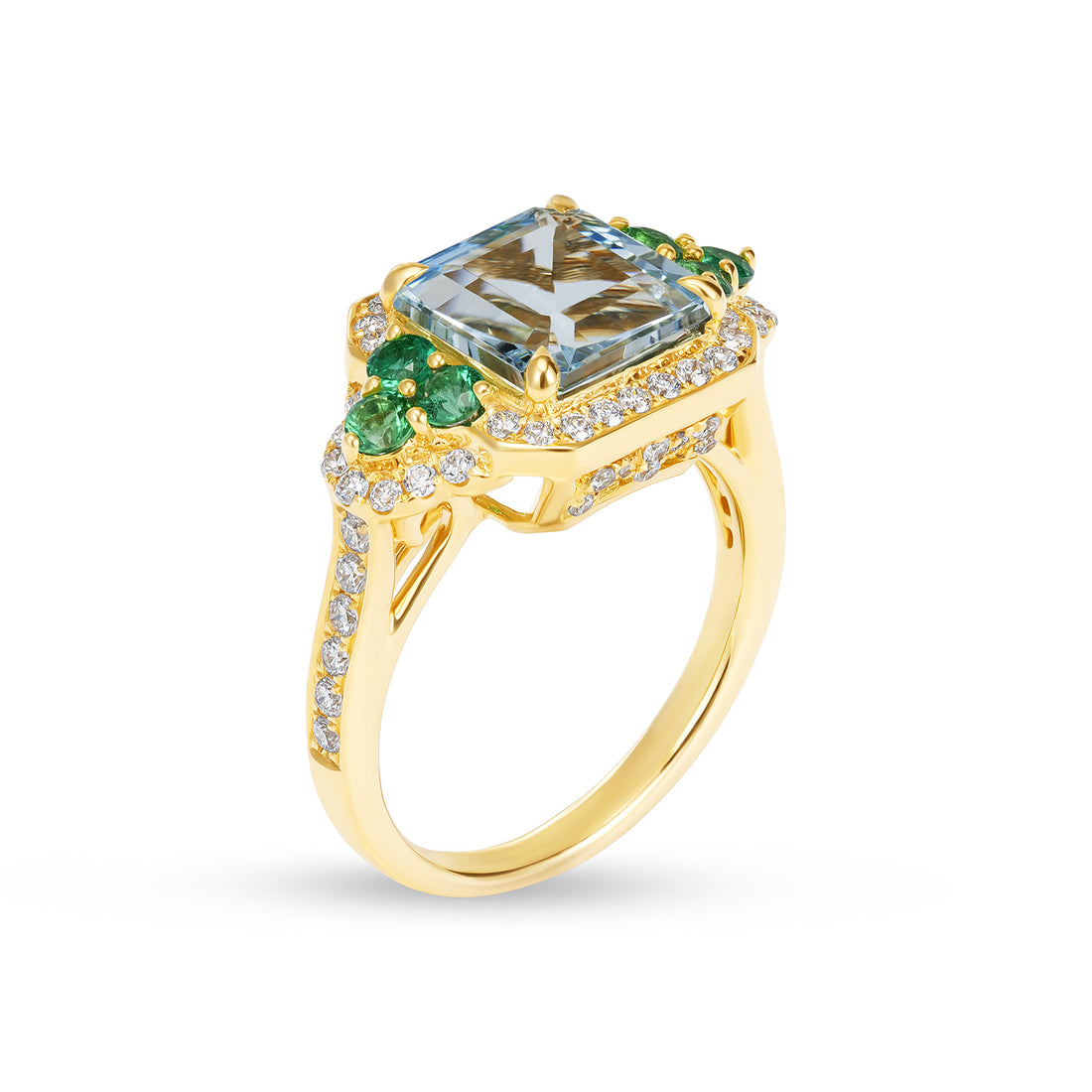 Gold ring with a large green gemstone and smaller emeralds on a white background