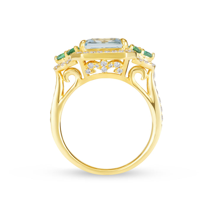 Gold ring with a central blue gemstone and green accents on a white background