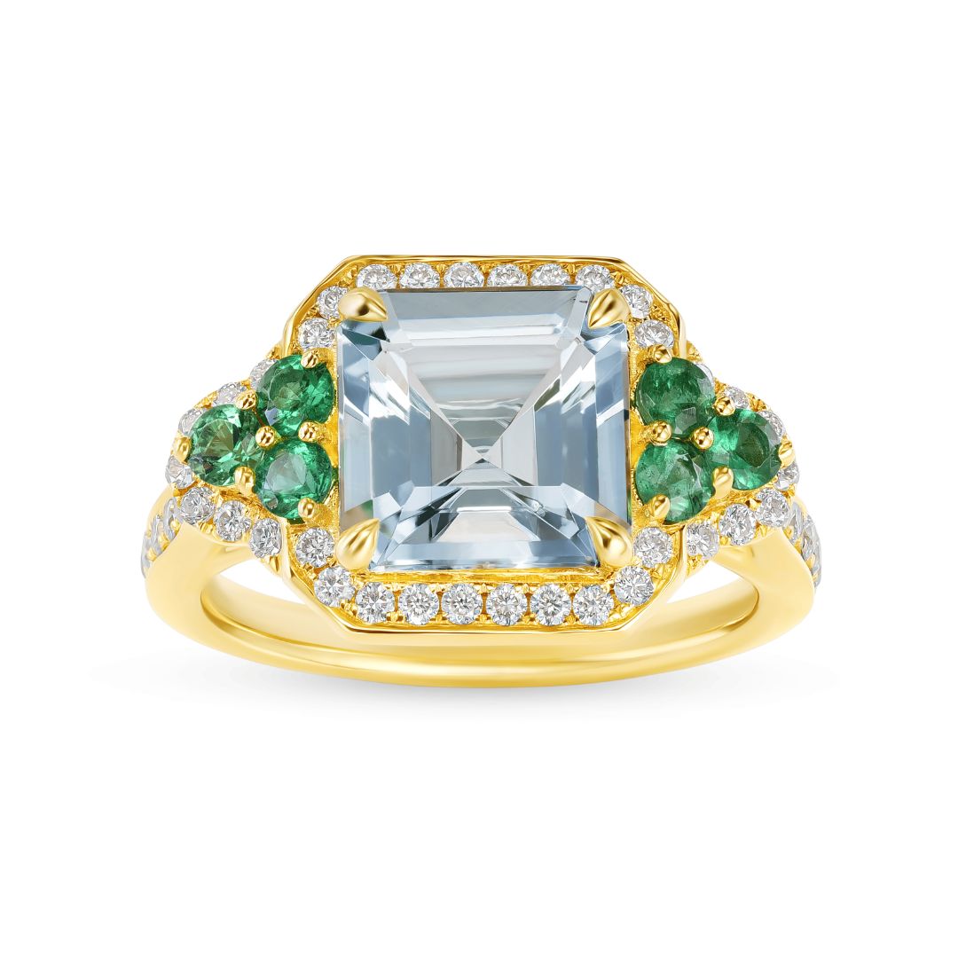 Gold ring with emeralds and diamonds on a white background