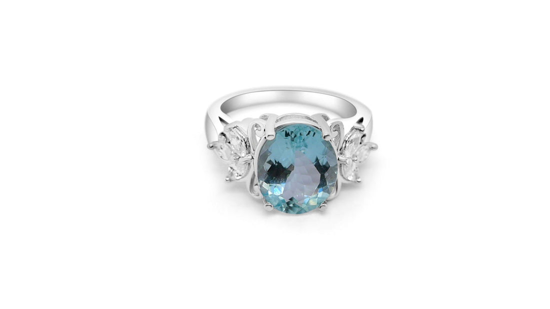Elegant rhodium plated aquamarine ring for women featuring an oval aquamarine and marquise white CZ accents