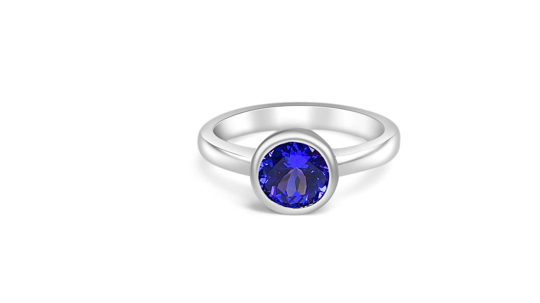 Stylish tanzanite engagement ring with a round gemstone set in rhodium plated 925 sterling silver