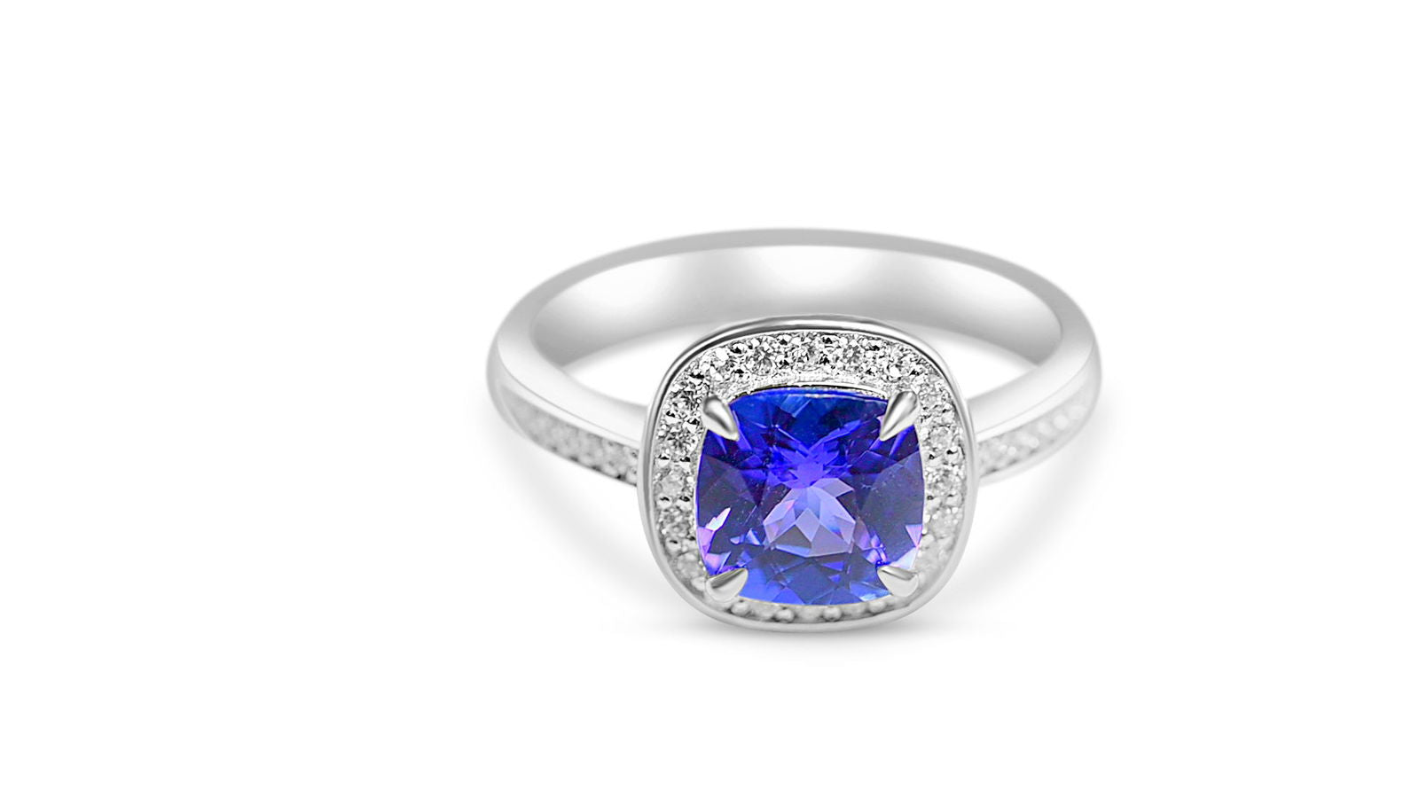 Unique tanzanite engagement ring featuring cushion-cut tanzanite and round white CZ in rhodium plated silver